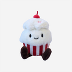 Plush toy resembling a cupcake with a white frosting, red and white striped base, and a cherry on top against a light gray background.