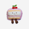 Plush toy resembling a layered cake with cherries on top against a white background